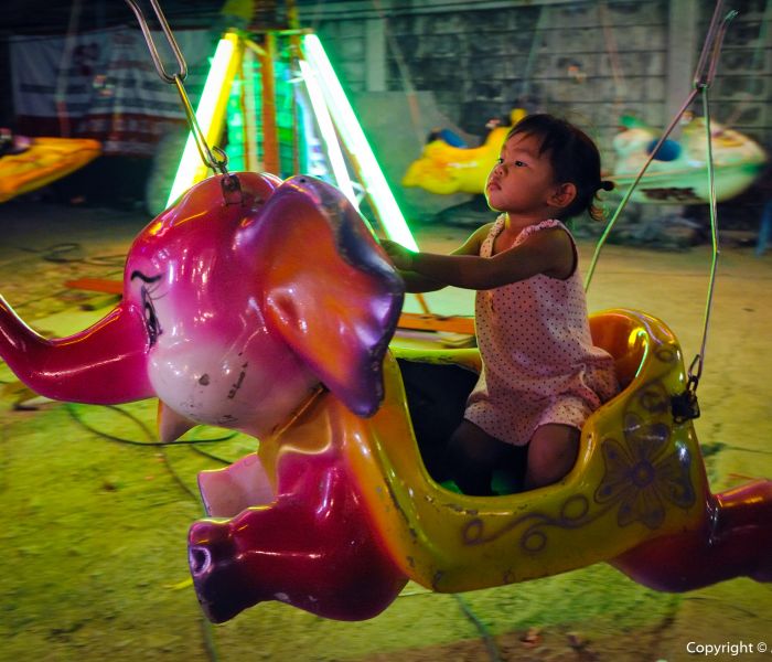 Driving the Elephant at a Funfair in Bangkok